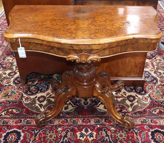 A Victorian burr walnut serpentine folding card table W.88cm